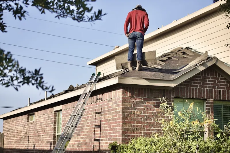 Professional roofer working on a residential roof in Cumru